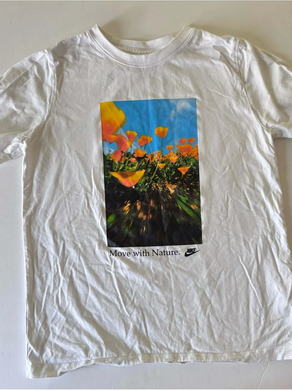 Nike White Kids Tee with Orange Floral Graphic and Blue Sky